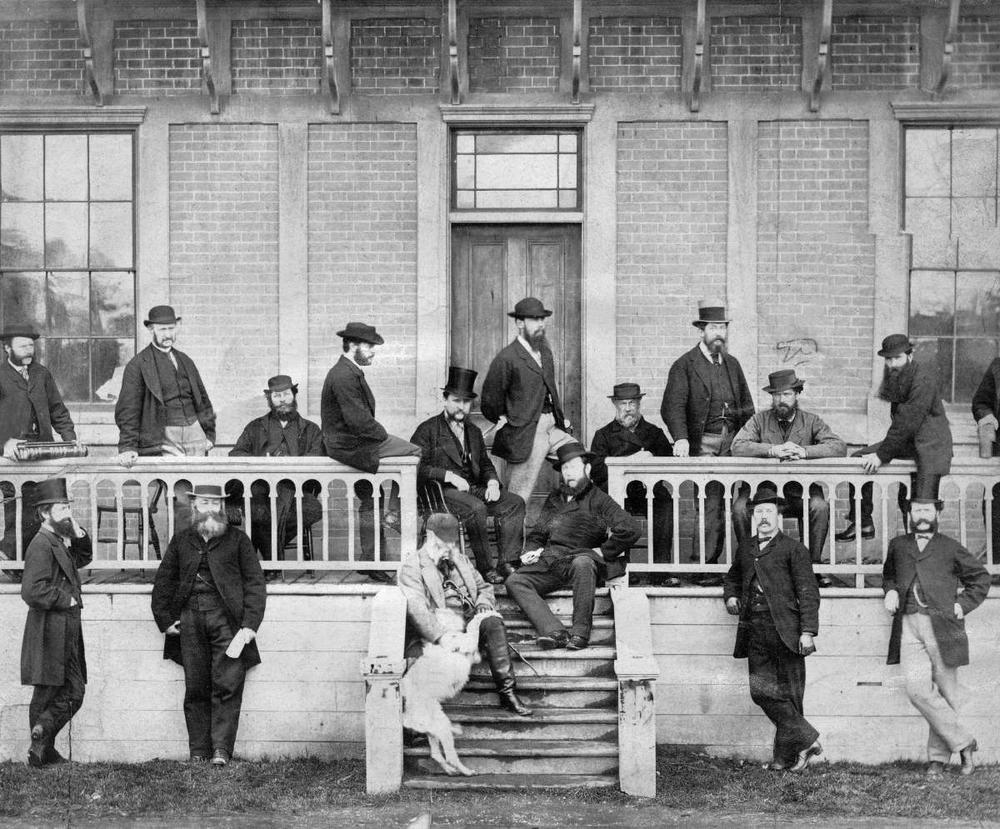 Members of the first Legislative Council following the union of Vancouver Island and British Columbia, in front of the Birdcages, Victoria, 1870.