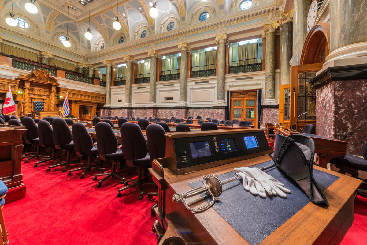 The desk of the Sergeant-at-Arms sits at the opposite end of the Chamber from the Speaker.