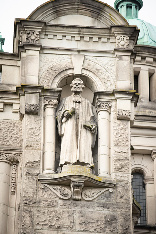 This statue of Sir Matthew Baillie Begbie is located on the exterior of the Legislative Library.