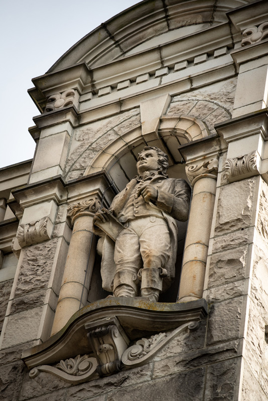 This statue of Sir Alexander Mackenzie is located on the exterior of the Legislative Library.
