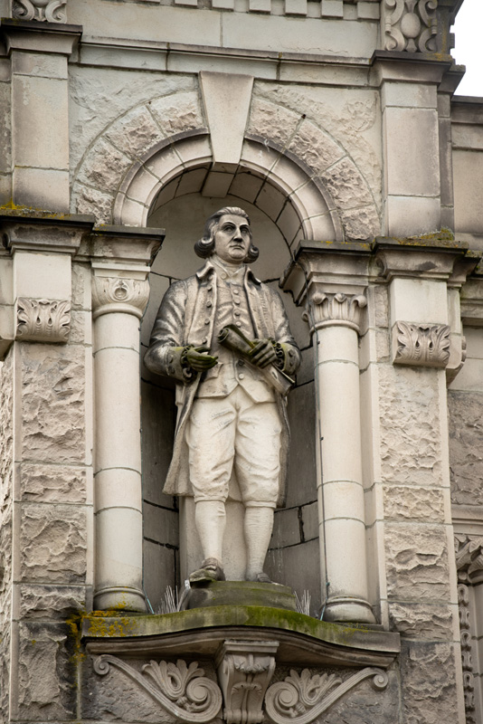 This statue of Captain George Vancouver is located on the exterior of the Legislative Library.