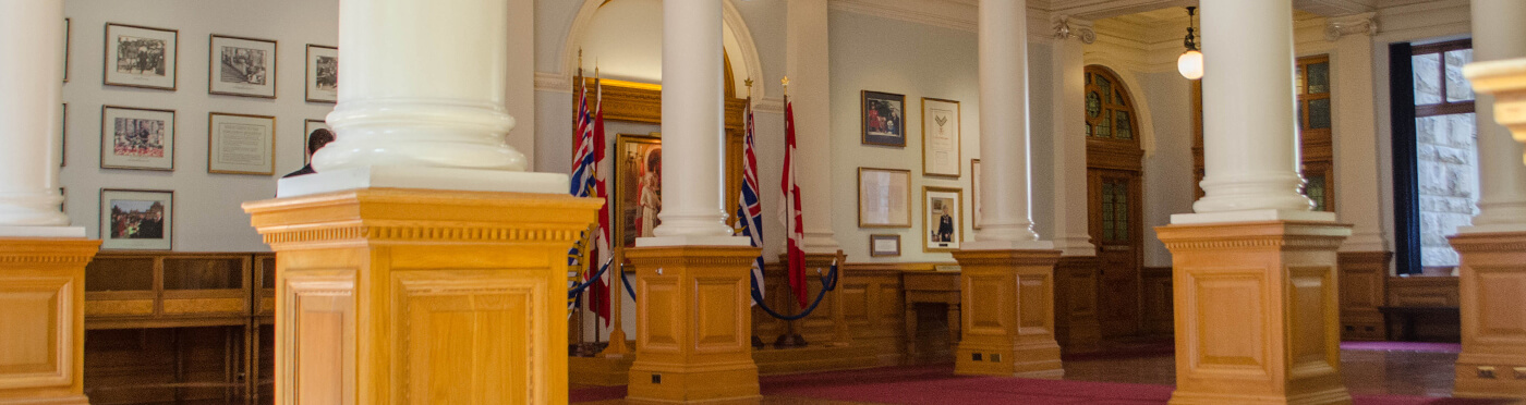Columns in hallway with British Columbia and Canada flags.