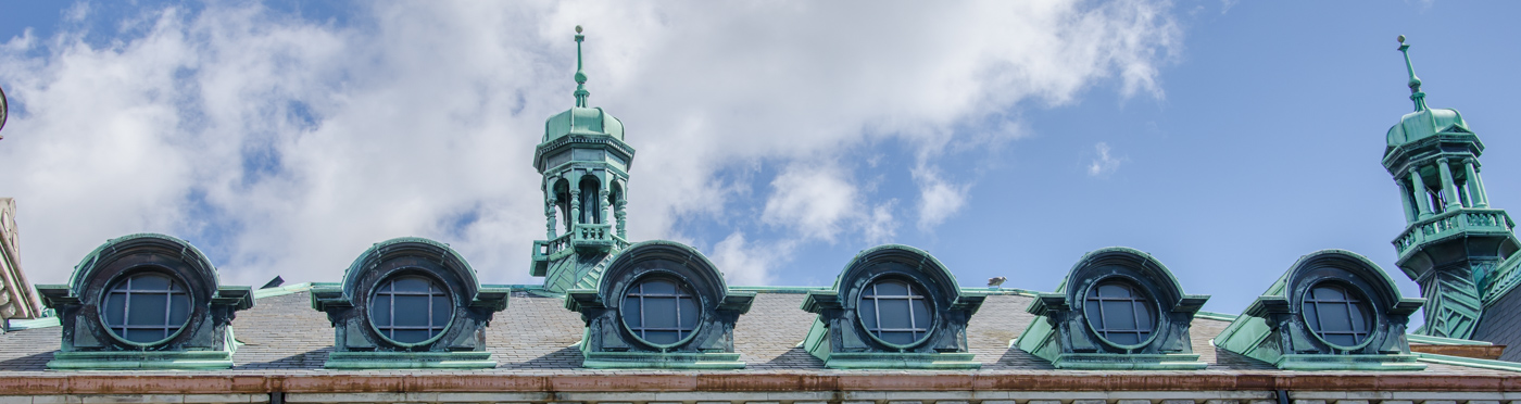Ornate windows and spires on rooftop.