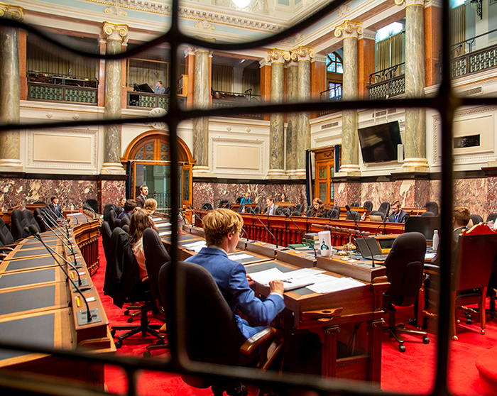 Legislative Interns sitting in the Chamber, view through the stained glass window 