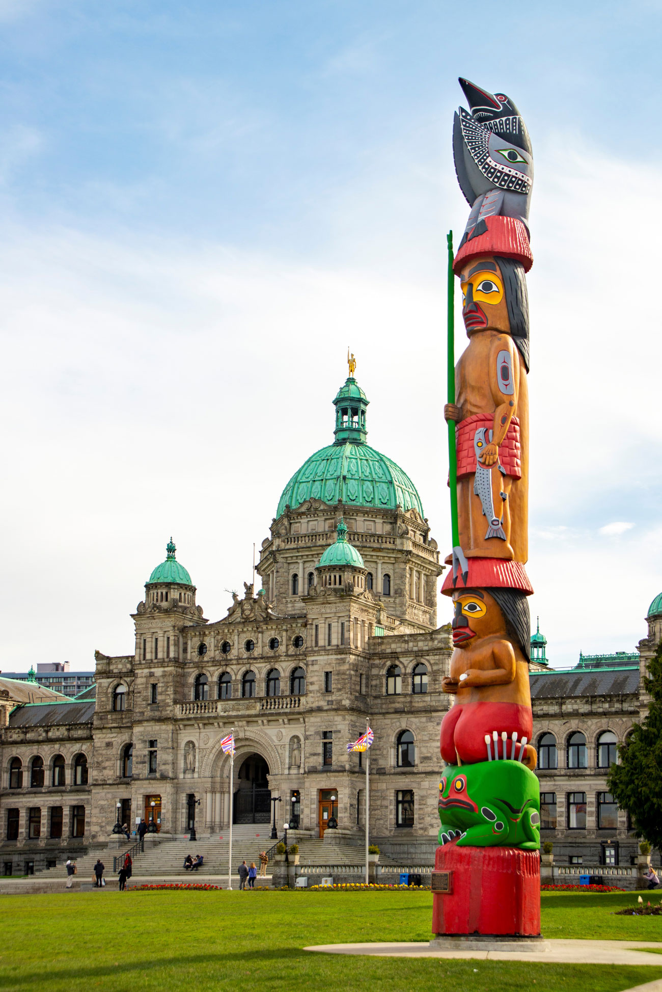 Vibrantly coloured totem pole in front of the Legislative Assembly building